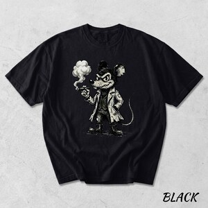 May include: Black t-shirt featuring a cartoon mouse character in a trench coat, smoking a cigar. The mouse has a stern expression and is drawn in a vintage, illustrative style. The word "BLACK" is printed in white at the bottom right.