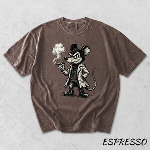 May include: Espresso-colored t-shirt featuring a cartoon mouse with a stern expression, wearing a coat and smoking a cigar. The graphic is in black and white. The word "ESPRESSO" is printed in white at the bottom of the shirt.