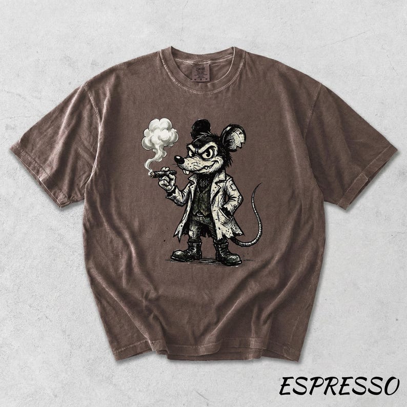 May include: Espresso-colored t-shirt featuring a cartoon mouse with a stern expression, wearing a coat and smoking a cigar. The graphic is in black and white. The word "ESPRESSO" is printed in white at the bottom of the shirt.