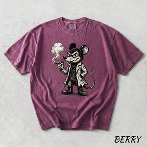 May include: Berry-colored t-shirt featuring a cartoon mouse smoking a cigar, dressed in a coat and boots. The graphic is in black and white. The word "BERRY" is printed in the bottom right corner.