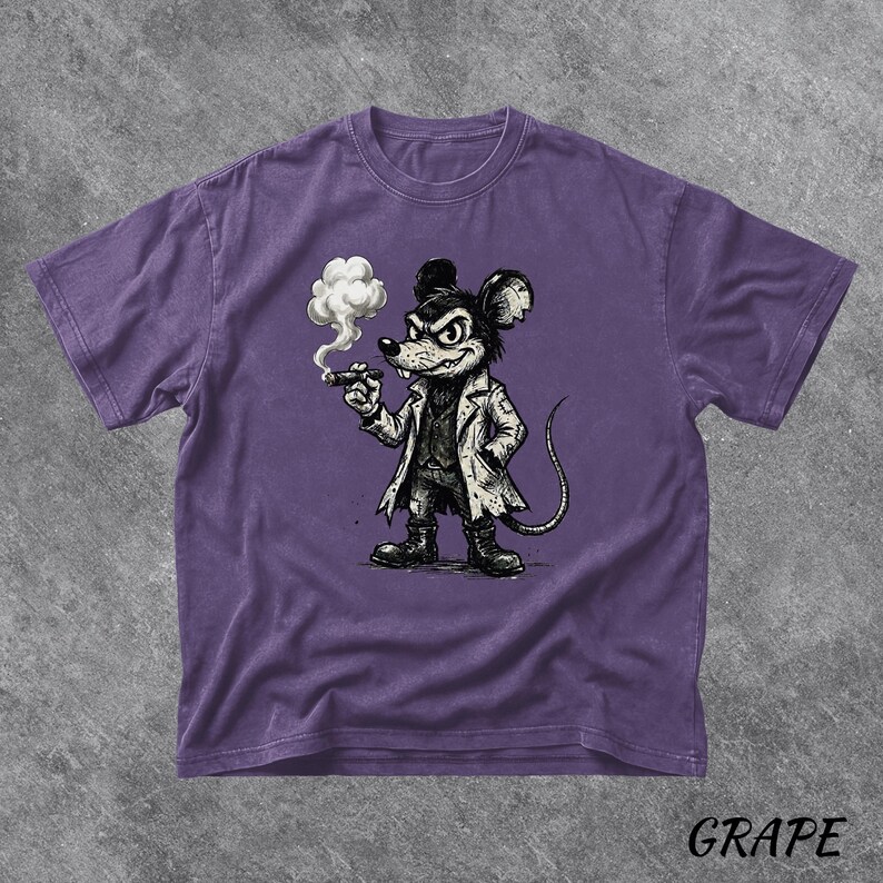May include: A purple t-shirt featuring a cartoon mouse in a white coat, smoking a cigar. The mouse has a stern expression. The word "GRAPE" is printed in the bottom right corner of the shirt.