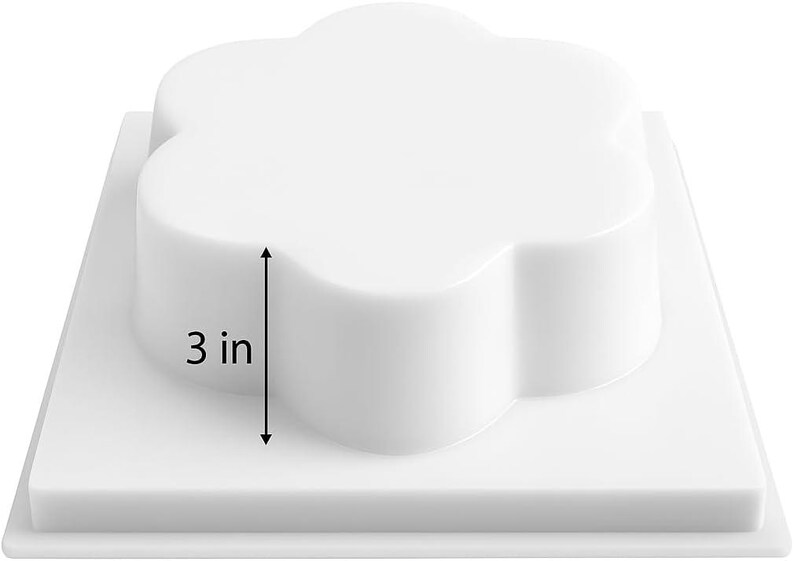 May include: A white, flower-shaped object, 7.6 cm tall, sits on a square base. The object has rounded edges and a smooth surface. The base is also white and square. The image is a product shot, likely for a mold or similar item.