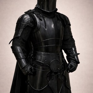 May include: A full suit of black armor, including a helmet, chest plate, and leg guards. The armor is highly polished, reflecting the light. The suit includes chainmail and leather gloves. The overall aesthetic is medieval.