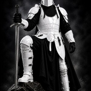 May include: A full suit of white armor with a black cape and a long sword. The knight is standing on a rock, with one knee bent. The helmet has a visor, and the armor includes shoulder pads, chest plates, and leg guards.
