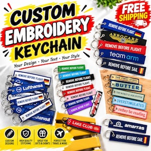 May include: A collection of rectangular fabric keychains featuring embroidered text and logos in various colors. Each keychain includes a metal split ring. Visible text includes REMOVE BEFORE FLIGHT, AEROCARE, team arm, REMOVE BEFORE SAIL, THE FIRST STATE, BUTTER, THE WORLD IS OUR OYSTER, OVERSTIMULATED, rather be reading, LAKE CLUB, and amarras.