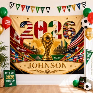 May include: A large rectangular wall tapestry featuring a gold soccer trophy, the text 2026, and the name JOHNSON. The design includes flags of the USA, Canada, and Mexico, a world map, and city landmarks. A banner above reads VIEWING PARTY.