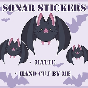 May include: A light purple background features three cartoon bat stickers with black bodies, pink ears, and pink noses. The text "SONAR STICKERS" is at the top. Below the bats are the words "MATTE" and "HAND CUT BY ME".