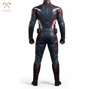 May include: A navy blue and red leather costume with white detailing. The costume comprises a jacket, trousers, and boots. The jacket features red and white stripes on the shoulders and back. The trousers have red accents. The boots are black with red trim.