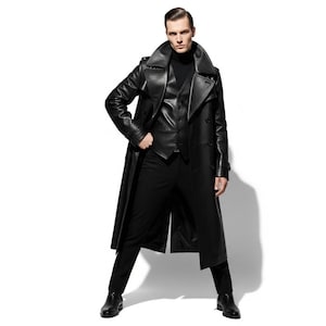 May include: A black leather trench coat with a matching vest and pants. The coat has a wide collar and button details. The outfit is completed with a black turtleneck and dress shoes. The overall look is sleek and stylish.