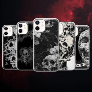 May include: A collection of five phone cases with skull designs. The cases feature various black and white skull illustrations, including floral and gothic-inspired patterns. Each case has a clear border.