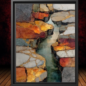 May include: Abstract art print in a black frame. The artwork depicts a river flowing between colorful, textured rock formations. The rocks feature shades of gray, orange, and gold, with a dark red background.