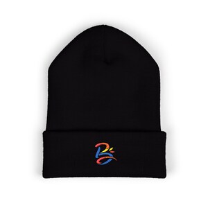 May include: Black beanie hat with a folded brim. The hat features a colorful embroidered design on the front. The design appears to be a stylized letter "B" in shades of red, yellow, and blue.