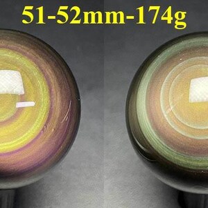 May include: Two polished obsidian spheres, each with a swirling pattern of yellow, purple, and green. The spheres are approximately 51-52mm in diameter and weigh 174g. The text "51-52mm-174g" is displayed above the spheres.