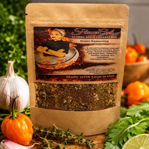 May include: A brown paper bag of "Flavor Gal" Green Seasoning. The label features a woman in a chef's outfit. The bag is filled with a blend of herbs and spices. Ingredients include onion, garlic, and Scotch bonnet pepper. The text "Made with Love in USA" is printed on the bag.