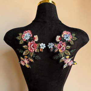 May include: A white ceramic mug with a black handle and the text "But First, Coffee" in a bold, black font. The mug is set against a blurred background, highlighting its clean design.