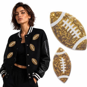 May include: A black varsity jacket featuring long sleeves and multiple gold sequin football patches with white stitching details. The jacket has a button-front closure and striped ribbed trim on the collar and cuffs, paired with two separate football patches.