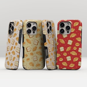 May include: Four phone cases featuring a repeating pattern of smiling bread, croissants, and rolls. The cases are in cream, tan, and red. The cases are designed to fit a smartphone.