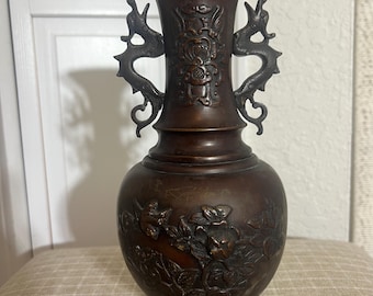 Antique East Asian bronze vase with dragon handles and floral motifs