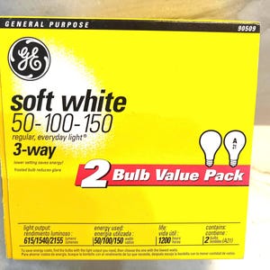 May include: A bright yellow GE General Purpose 3-way soft white light bulb box. The packaging features the text 50-100-150, 2 Bulb Value Pack, and technical specifications including light output of 615/1540/2155 lumens and 1200 hours of life.