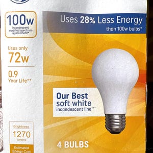 May include: A box of GE soft white light bulbs. The box is white and yellow with text that reads "100w", "Uses 28% Less Energy", and "Our Best soft white incandescent line". The box contains 4 bulbs.