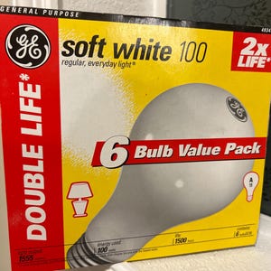May include: A yellow and red box of GE soft white 100-watt light bulbs. The box features the GE logo, the words "soft white 100", and "6 Bulb Value Pack". The box also has the words "Double Life" and "2x Life".