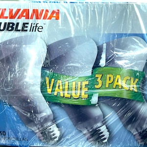 May include: A package of three Sylvania Double Life flood light bulbs. The package is wrapped in clear plastic and features the text "VALUE 3 PACK". The bulbs are 65W and designed for indoor use.