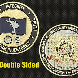 May include: Double-sided gold and black coin featuring the South Carolina flag and the words "Honesty, Integrity, Truth." The reverse side displays the Greenville County Sheriff's Office emblem and text.