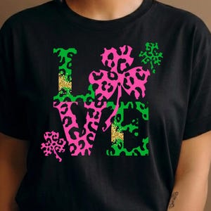 May include: A white ceramic mug with a black handle and the text "But First, Coffee" in a black, handwritten-style font. The mug is on a white surface.