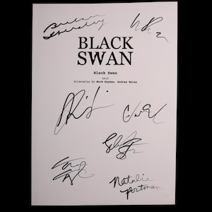 May include: A white paper with the title "BLACK SWAN" in large black letters. Below the title are the words "Black Swan" and "2010". The paper is covered in black signatures, including "Natalie Portman".