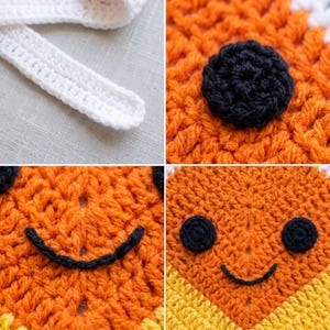 May include: A crochet item featuring orange, yellow, and white yarn. The piece includes a white strap, a black circular eye, and a black stitched smile. The texture is created with visible yarn loops, showcasing a detailed handmade construction.