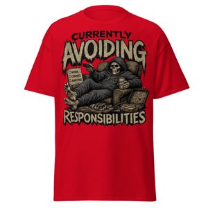 May include: Red t-shirt with a graphic of a skeleton in a hoodie relaxing in a chair, holding a remote and a drink. The text reads "Currently Avoiding Responsibilities" with a checklist for work, chores, and adulting.