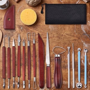 May include: A pottery tool set including wooden modeling tools, a yellow sponge, a black zippered pouch, metal wire loop tools, a metal knife, a needle tool, and two ball stylus tools with light blue handles arranged on a wooden surface.