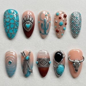 May include: A collection of ten artificial nails with various designs. The nails feature turquoise, silver, and brown accents. Designs include a bear paw, cactus, feather, and geometric patterns. The nails are oval-shaped and have a glossy finish.