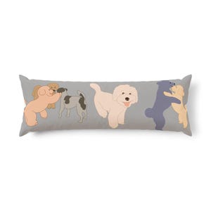 May include: A long rectangular throw pillow with a gray background featuring a repeating illustration of various dogs. The design includes light brown, white, and dark blue dogs in playful poses, some standing and others hugging each other.