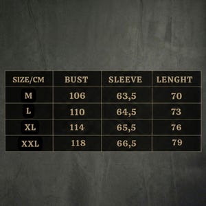 May include: A size chart with measurements in centimeters for a garment. The chart includes sizes M, L, XL, and XXL, with corresponding bust, sleeve, and length measurements. The background is a dark, textured surface.