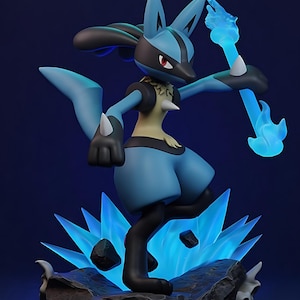 Puede incluir: Figura de Lucario azul y negro en pose dinámica, sosteniendo un báculo de energía azul. La figura se alza sobre una base rocosa con formaciones de cristal azul, sobre un fondo azul oscuro. La figura mide unos 15 cm de altura.