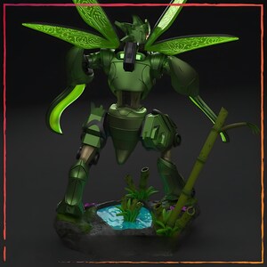 May include: A green robot figurine with insect-like wings and a detailed design. The robot stands on a base with a small pond and bamboo stalks. The wings have a circuit board pattern.