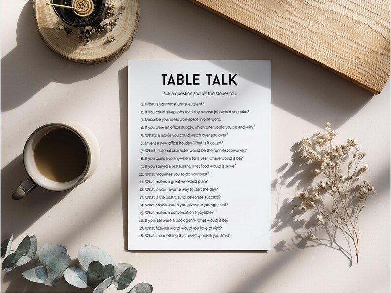 May include: A top-down view of a sheet of paper with the title "TABLE TALK" and discussion prompts. A coffee cup, decorative elements, and a wooden board are arranged around it.