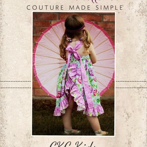 May include: A young child wearing a floral print dress with pink ruffles and a matching bow. The child is holding a pink parasol. The image includes the text "CKC Patterns" and "CKC Kids".