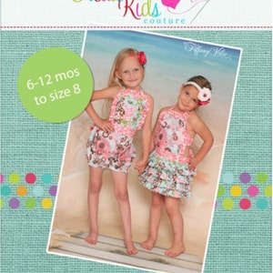 May include: Two girls wearing floral print dresses with ruffles. The dresses are pink, blue, and white. The girls are standing on a wooden surface. The image has a green background with the text "Create Kids Couture" and "handmade with love" at the top and bottom.