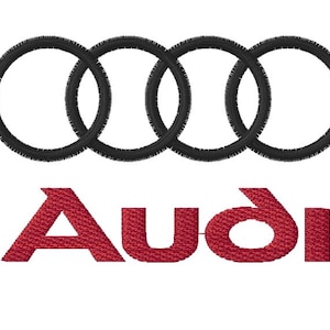 May include: Embroidered Audi logo featuring four interlocking black rings above the red word "Audi". The design is on a white background. The logo is commonly associated with the German automobile manufacturer.
