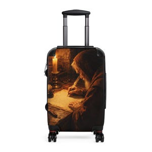 May include: A rolling suitcase with a vintage illustration of a robed figure writing by candlelight. The image shows an old man with a long white beard, quill in hand, lit by a glowing candle. The suitcase has a black handle and wheels.