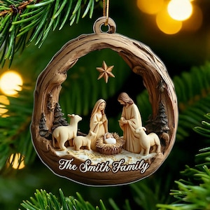 May include: A circular wooden-textured Christmas ornament featuring a nativity scene with figures of Mary, Joseph, and baby Jesus in a manger, accompanied by two sheep, pine trees, and a star, with the text The Smith Family printed at the bottom.