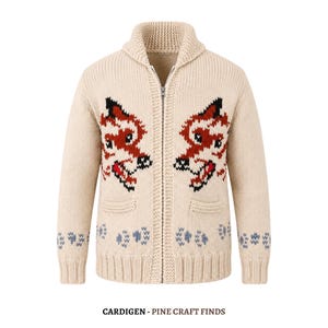May include: A beige knit zip-up cardigan featuring a shawl collar and two front pockets. The garment displays a red, black, and white fox face pattern on each side of the chest and a light blue paw print design along the bottom hem and cuffs.