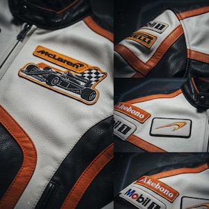 May include: A white and black leather racing jacket with orange accents. The jacket features multiple patches, including the McLaren logo and other sponsor logos. The jacket has a zipper closure and a black collar.