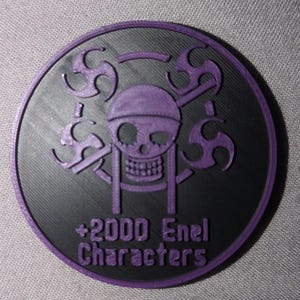 May include: A round, black and purple emblem featuring a skull and crossbones design with swirling accents. The text "+2000 Enel Characters" is printed in purple. The emblem has a textured surface.