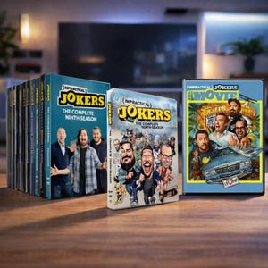 May include: A collection of "Impractical Jokers" DVD sets, including "The Complete Ninth Season," "The Complete Tenth Season," and "The Movie." The covers feature images of the cast and the show's logo against a blue background. The sets are arranged on a wooden surface.