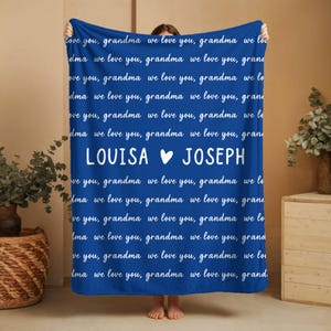May include: A blue blanket with white text that reads "love you, grandma we love you." The blanket has the names "LOUISA" and "JOSEPH" with a heart symbol. A cozy, personalized gift.