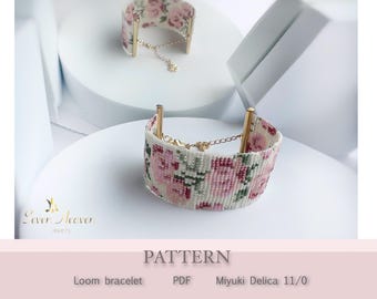 May include: Two loom bracelets with a floral pattern in pink, white, and green. The bracelets have gold-colored accents and are displayed on a white surface. The word "PATTERN" is visible.