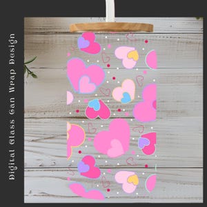 May include: A clear glass can wrap design with a pattern of pink, purple, and yellow hearts. The design includes small white dots and the text "Digital Glass Can Wrap Design". The top of the glass has a wooden lid.